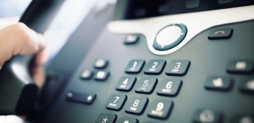Dialing a telephone in the office Dialing telephone keypad concept for communication, contact us and customer service support
