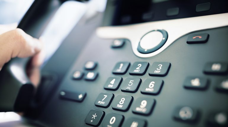Dialing a telephone in the office Dialing telephone keypad concept for communication, contact us and customer service support