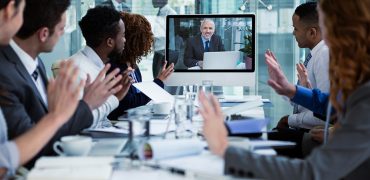 Business people looking at a screen during a video conference 808810