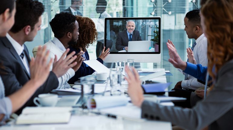 Business people looking at a screen during a video conference 808810